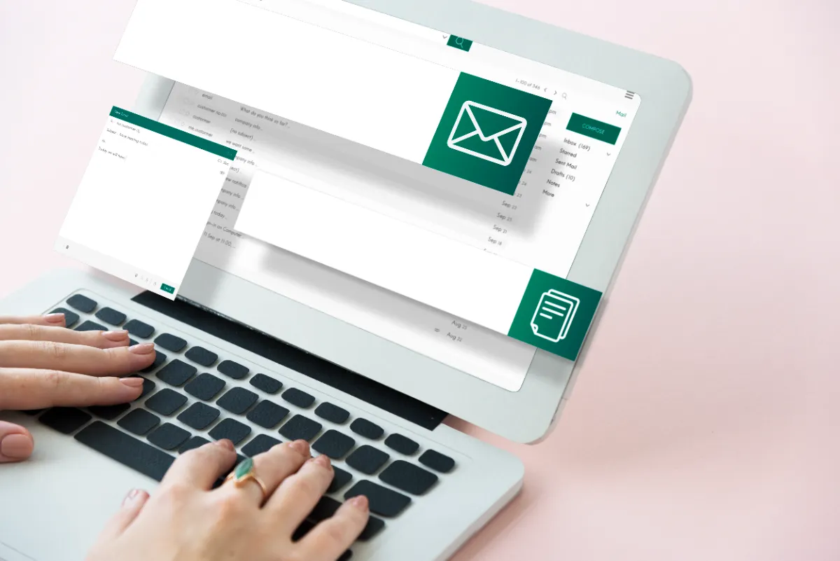 A person typing a professional email on a laptop
